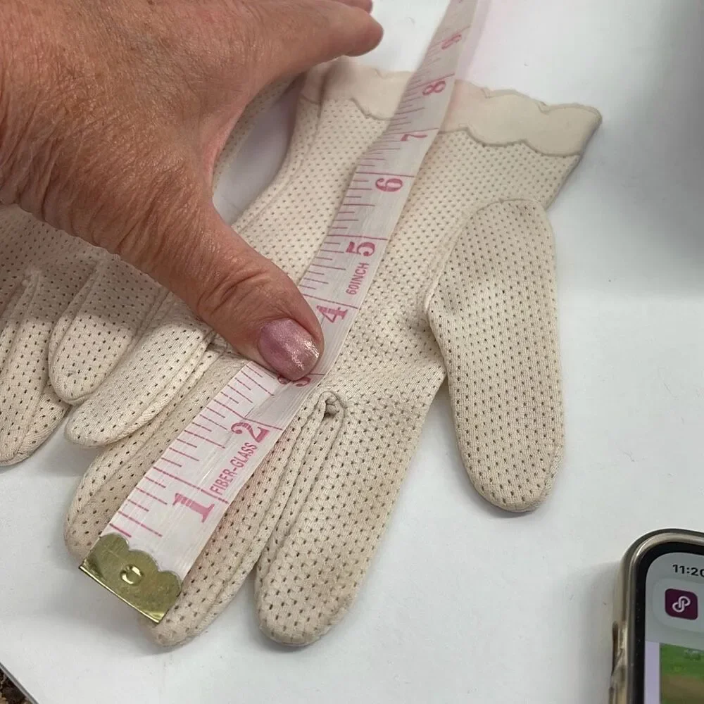 Vintage cream colored perforated gloves scalloped edges.